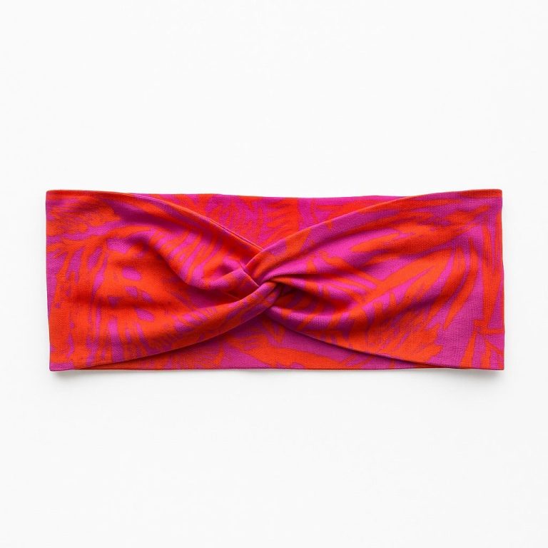 Fuchsia Haarband mit elegantem Knoten und lebhaftem Muster.