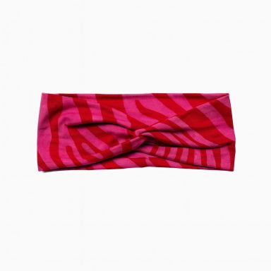 Rotes Stirnband mit zebraähnlichem Muster und Knoten in der Mitte.